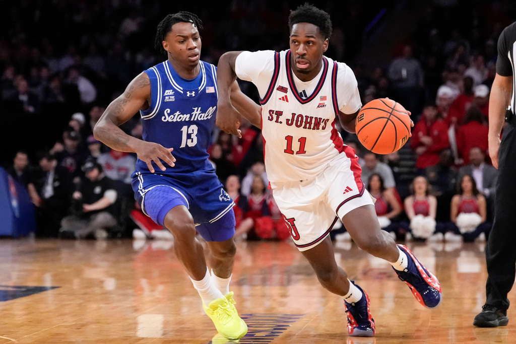 St. John's guard Ian Jackson (11) drives past Seton Hall guard Trey Parker (13) during the first half of an NCAA college basketball game in the semifinals of the Big East tournament, Friday, March 13, 2026, in New York. (AP Photo/Yuki Iwamura)