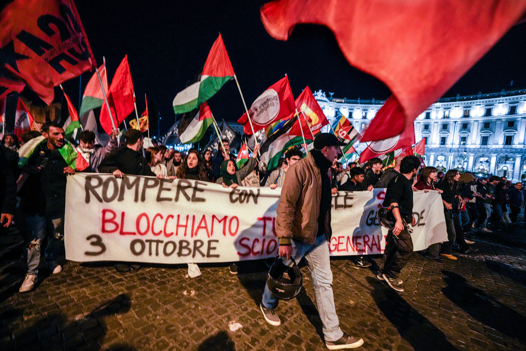Pro-Palestinian activists march in downtown Rome late Wednesday, Oct. 1, 2025, after news that a Gaza-bound aid flotilla had been intercepted by Israeli forces in the Mediterranean Sea. (AP Photo/Andrew Medichini)