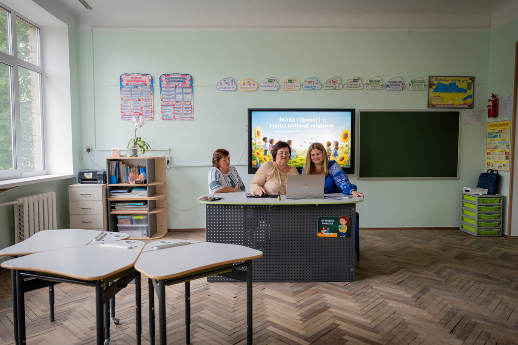 Teachers conduct online lessons for elementary students from a public school damaged by a Russian attack, in Kyiv, Tuesday, Sept. 1, 2026. (AP Photo/Dan Bashakov)