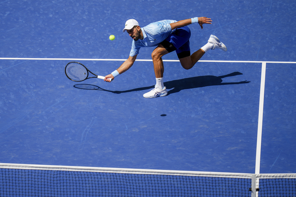 Novak Djokovic, of Serbia, returns a shot to Zachary Svajda, of the United States, during the second round of the U.S. Open tennis championships, Wednesday, Aug. 27, 2025, in New York. (AP Photo/Kirsty Wigglesworth)