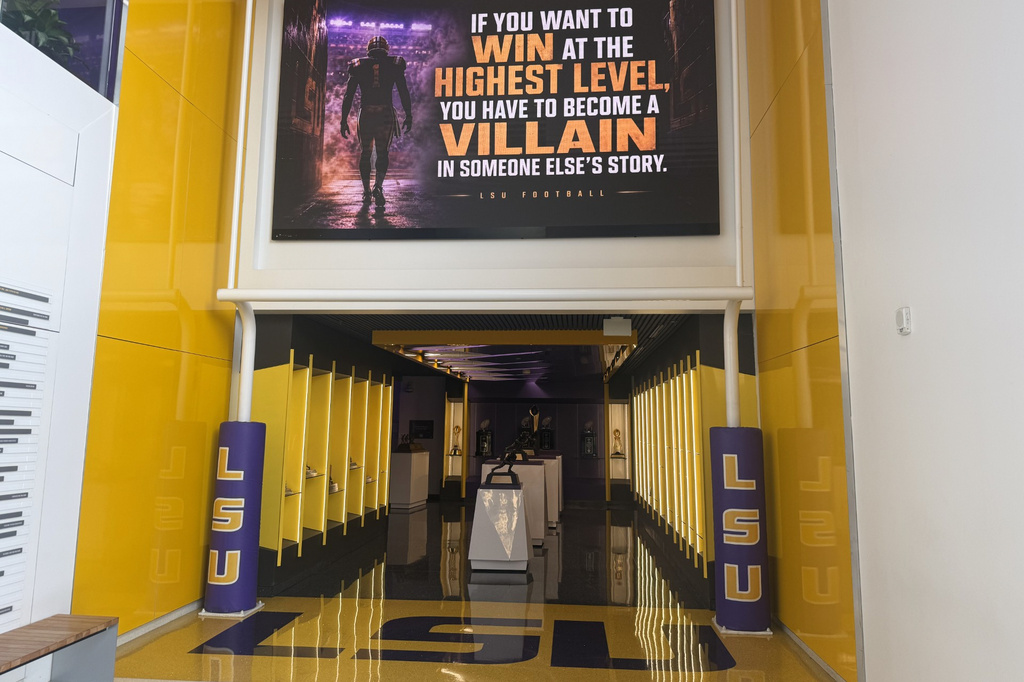 A quote hangs above a trophy display room near the entrance of the LSU Football Operations Center Monday, Aug. 31, 2026, in Baton Rouge, La. (AP Photo/Brett Martel)