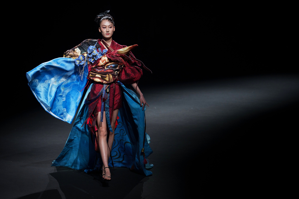 A model wears a creation by "The Urban Plette" Weaving Starry Dreams China International Children Designer Competition, during China Fashion Week (Spring) 2026 in Beijing, China, Sunday, March 22, 2026. (AP Photo/Vincent Thian)