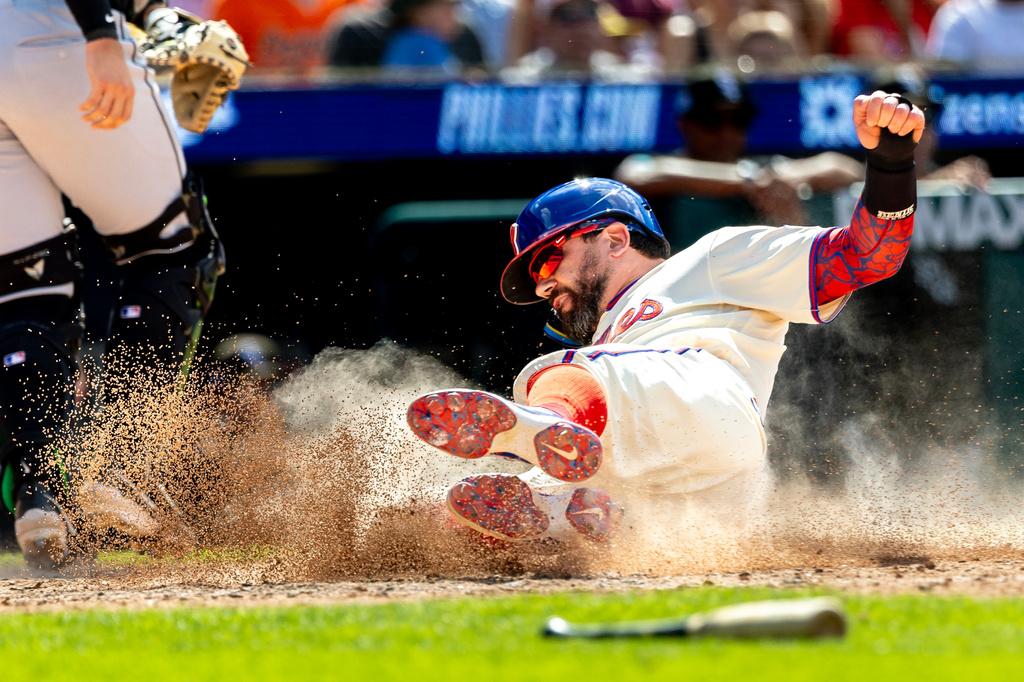 Philadelphia Phillies designated hitter Kyle Schwarber scores on an RBI single hit by Brandon Marsh during the sixth inning of a baseball game against the Chicago White Sox, Sunday, June 7, 2026, in Philadelphia. (AP Photo/Laurence Kesterson)