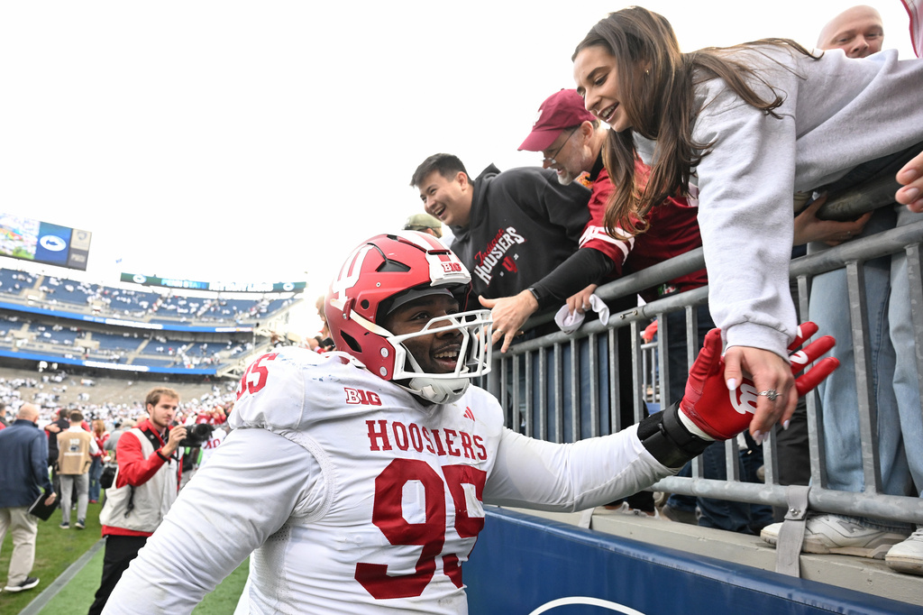 FILE - Indiana defensive lineman Tyrique Tucker (95) celebrates a win over Penn State following an NCAA college football game, Saturday, Nov. 8, 2025, in State College, Pa. (AP Photo/Barry Reeger, file)