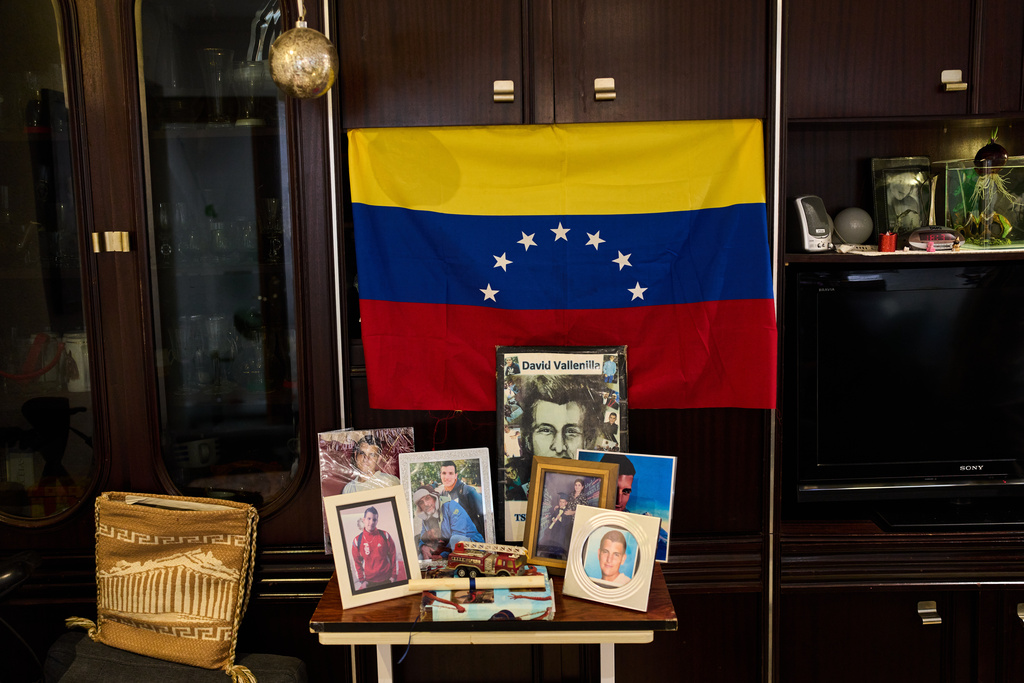Pictures of the late David José Vallenilla Luis are placed in the living room of his father, David José Vallenilla, in Madrid, Tuesday, Jan. 13, 2026. (AP Photo/Bernat Armangue)