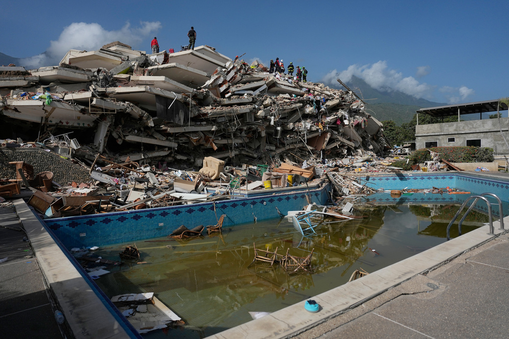 Rescue workers search through the rubble three days after earthquakes struck Catia La Mar, Venezuela, Saturday, June 27, 2026. (AP Photo/Fernando Vergara)