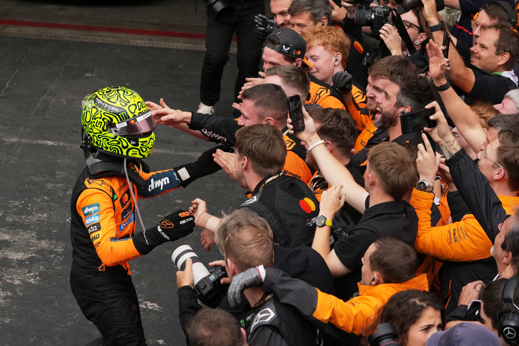 McLaren driver Lando Norris of Britain celebrates with teammates after winning the Brazilian Formula One Grand Prix at the Interlagos race track in Sao Paulo, Sunday, Nov. 9, 2025. (AP Photo/Andre Penner)
