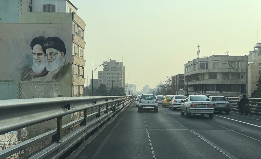 Vehicles drive past portrait of the late Iranian revolutionary founder Ayatollah Khomeini, left, and Supreme Leader Ayatollah Ali Khamenei, in downtown Tehran, Iran, Sunday, Jan. 25, 2026. (AP Photo/Vahid Salemi)