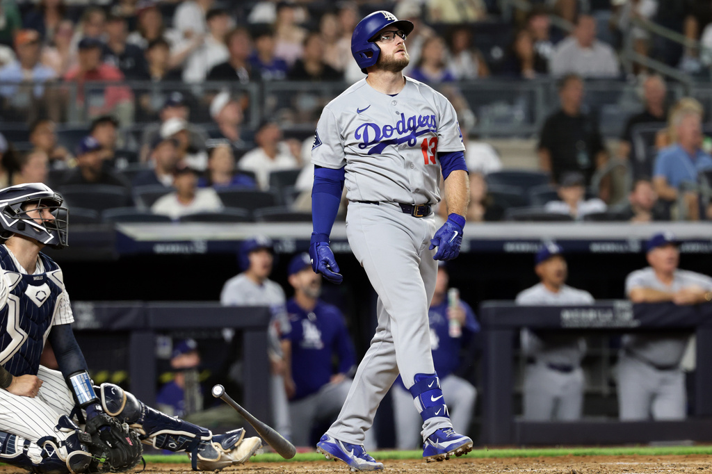 Los Angeles Dodgers' Max Muncy, right, watches his two-run home run during the seventh inning of a baseball game against the New York Yankees, Friday, July 17, 2026, in New York. (AP Photo/Adam Hunger)