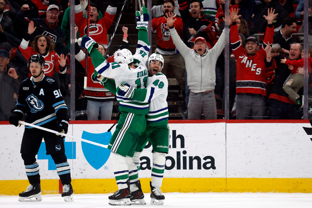 Carolina Hurricanes' Jordan Staal (11) is celebrates after his winning goal with teammate Jordan Martinook (48) with Utah Mammoth's Mikhail Sergachev (98) nearby during the third period of an NHL hockey game in Raleigh, N.C., Thursday, Jan. 29, 2026. (AP Photo/Karl DeBlaker)