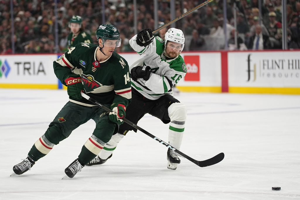 Minnesota Wild center Joel Eriksson Ek (14) and Dallas Stars center Sam Steel (18) battle for the puck during the second period of Game 3 in the first round of the NHL Stanley Cup hockey playoffs Wednesday, April 22, 2026, in St. Paul, Minn. (AP Photo/Abbie Parr)