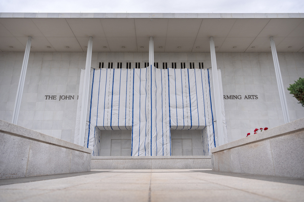 The John F. Kennedy Center for the Performing Arts is seen, as its sign remains covered by a tarp, Friday, June 19, 2026, in Washington. (AP Photo/Mark Schiefelbein)
