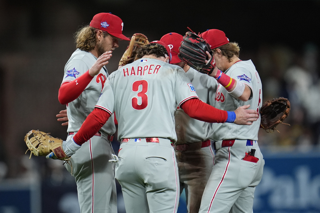 Philadelphia Phillies first baseman Bryce Harper (3) celebrates with teammates after the Phillies defeated the San Diego Padres 4-3 in a baseball game Tuesday, May 26, 2026, in San Diego. (AP Photo/Gregory Bull)