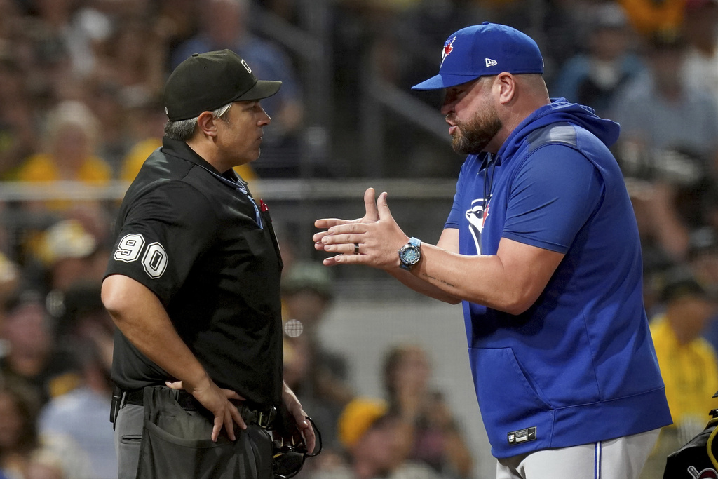 Toronto Blue Jays manager John Schneider, right, argues with home plate umpire Mark Ripperger, left, after Schneider was thrown out during the seventh inning of a baseball game against the Pittsburgh Pirates, Monday, Aug. 18, 2025, in Pittsburgh. (AP Photo/Matt Freed)