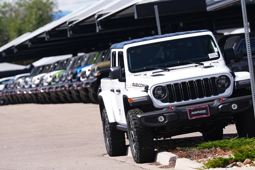 FILE - Unsold 2025 Gladiator pickup trucks sit on display outside a Jeep dealership Friday, Sept. 26, 2025, in Englewood, Colo. (AP Photo/David Zalubowski, File) FILE - Unsold 2025 Gladiator pickup trucks sit on display outside a Jeep dealership Friday, Sept. 26, 2025, in Englewood, Colo. (AP Photo/David Zalubowski, File)