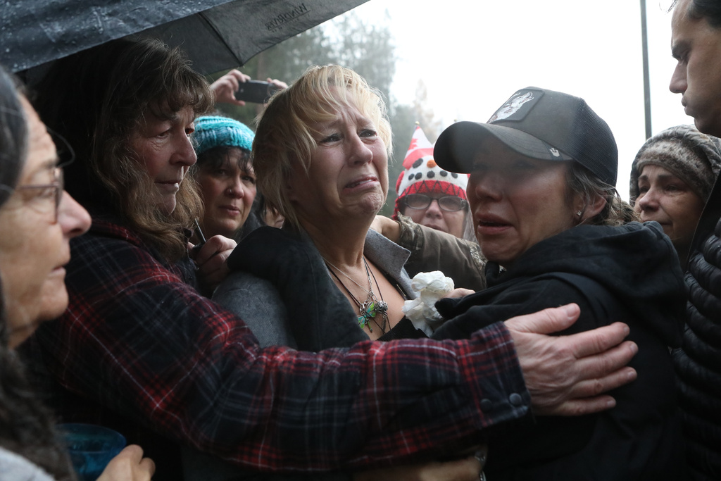 Karen Espersen, the co-owner of Universal Ostrich Farms, is embraced by supporters and her daughter, Katie Pasitney, at the farm in Edgewood, B.C., following the announcement that the Supreme Court of Canada dismissed the farm's appeal to stay an order to cull more than 300 of its ostriches on Thursday, Nov. 6, 2025. (Aaron Hemens /The Canadian Press via AP)