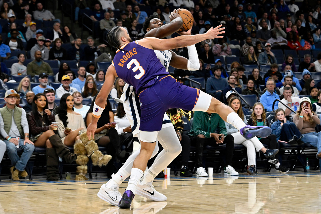 Memphis Grizzlies forward Jaren Jackson Jr. (8) looks to shoot against Phoenix Suns guard Dillon Brooks (3) in the first half of an NBA basketball game Wednesday, Jan. 7, 2026, in Memphis, Tenn. (AP Photo/Brandon Dill)