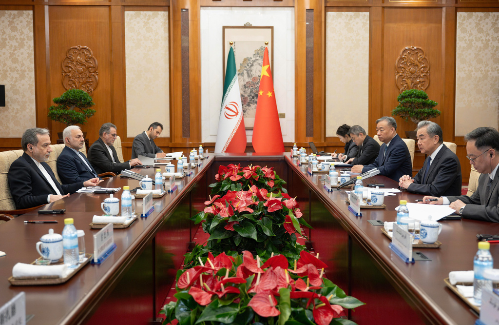 In this photo released by Xinhua News Agency, Chinese Foreign Minister Wang Yi, second right, talks to his Iranian Counterpart Abbas Araghchi, left, during the bilateral meeting in Beijing, Wednesday, May 6, 2026. (Cai Yang/Xinhua via AP)