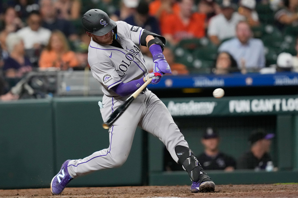 Colorado Rockies' Hunter Goodman hits a home run against the Houston Astros during the fourth inning of a baseball game Thursday, April 16, 2026, in Houston. (AP Photo/David J. Phillip)