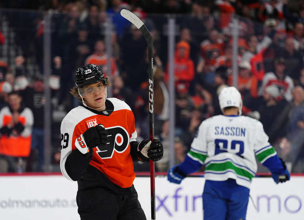 Philadelphia Flyers' Nikita Grebenkin, left, celebrates after scoring during the second period of an NHL hockey game against the Vancouver Canucks, Monday, Dec. 22, 2025, in Philadelphia. (AP Photo/Derik Hamilton)