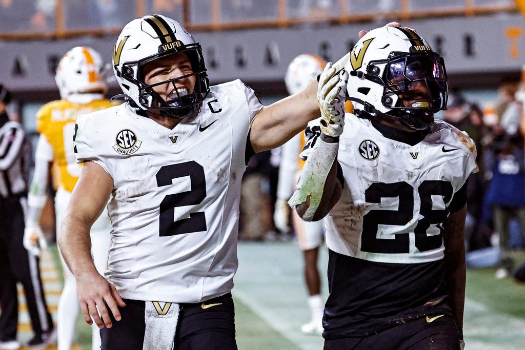 Vanderbilt running back Sedrick Alexander (28) celebrates with quarterback Diego Pavia (2) after scoring a touchdown during the second half of an NCAA college football game against Tennessee, Saturday, Nov. 29, 2025, in Knoxville, Tenn. (AP Photo/Wade Payne)