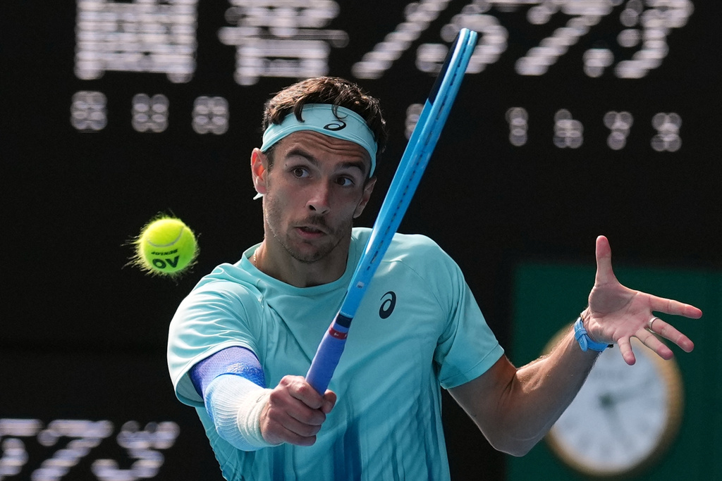 Lorenzo Musetti of Italy plays a backhand return to Novak Djokovic of Serbia during their quarterfinal match at the Australian Open tennis championship in Melbourne, Australia, Wednesday, Jan. 28, 2026. (AP Photo/Dita Alangkara)