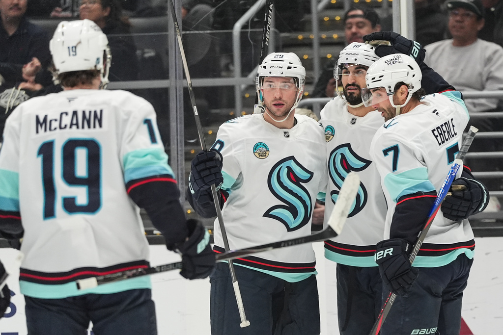 Seattle Kraken defenseman Vince Dunn (29) celebrates his goal with left wing Jared McCann (19), center Matty Beniers (10) and right wing Jordan Eberle (7) during the first period of an NHL hockey game Wednesday, Feb. 4, 2026, in Los Angeles. (AP Photo/Jae C. Hong)