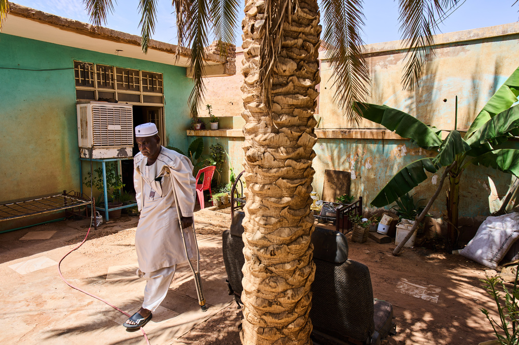 Tariq Abuzeid, 52, who lost his leg in a shelling attack, walks in the patio of his home in Omdurman, Sudan, Saturday, April 25, 2026. (AP Photo/Bernat Armangue)