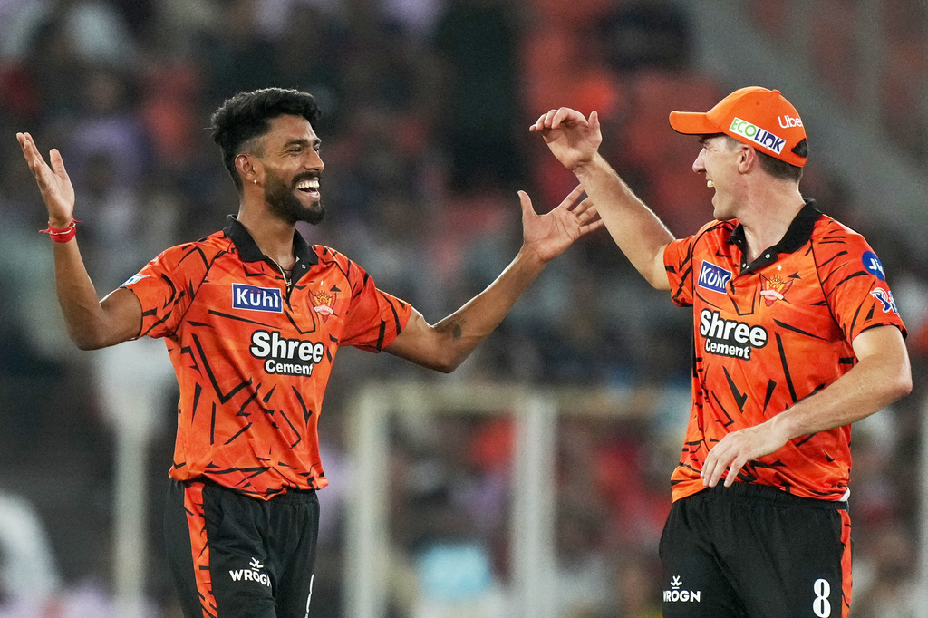 Sunrisers Hyderabad's Praful Hinge, left and Pat Cummins celebrates the wicket of Gujarat Titans' Jos Buttler during the Indian Premier League cricket match between Gujarat Titans and Sunrisers Hyderabad, in Ahmedabad, India, Tuesday, May 12, 2026. (AP Photo/Ajit Solanki)
