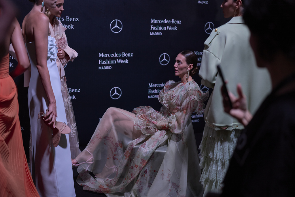 Models wear designs by Isabel Sanchis backstage during the brand's show at Fashion Week in Madrid, Spain, Friday, Sept. 19, 2025. (AP Photo/Manu Fernandez)