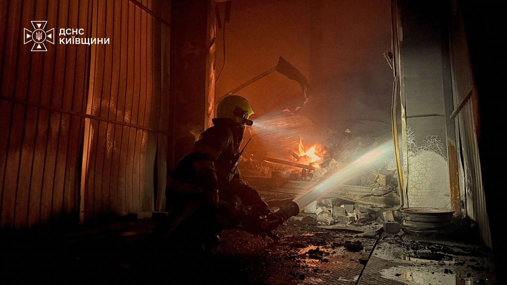 In this photo provided by the Ukrainian Emergency Service, firefighters put out a fire in a warehouse following a Russian drone attack near Kyiv, Ukraine, Wednesday, Sept. 2, 2026. (Ukrainian Emergency Service via AP)