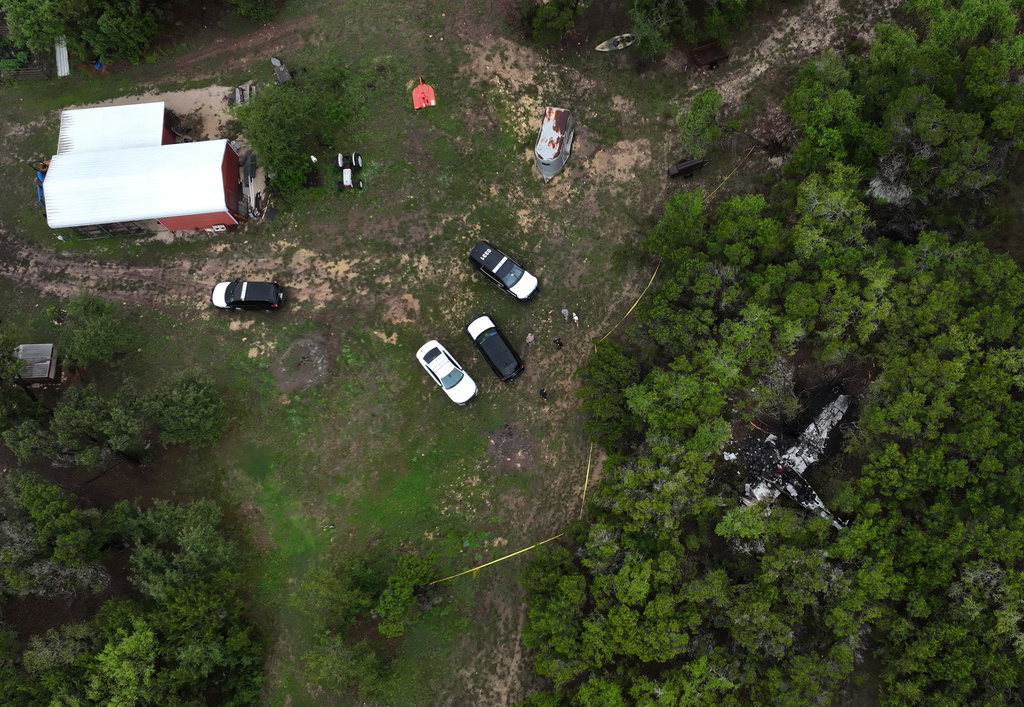 A crashed Cessna airplane is seen in a wooded area on Round Rock Road in Wimberley, Texas, Friday, May 1, 2026. (Jay Janner/Austin American-Statesman via AP)