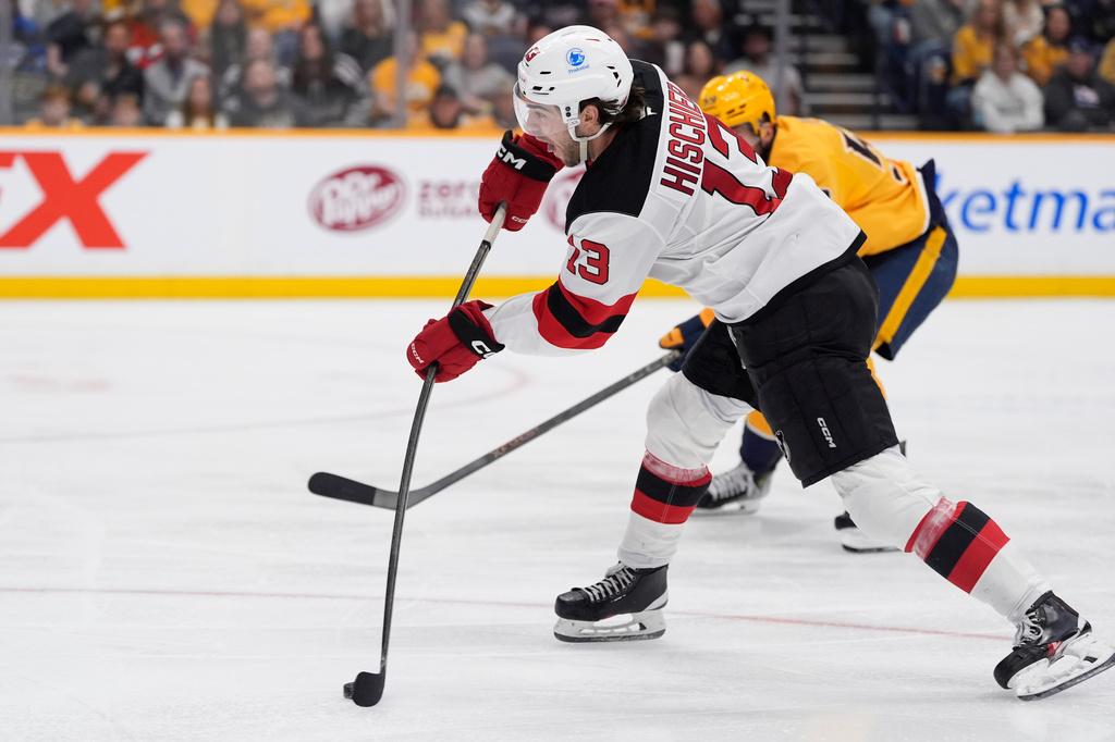 New Jersey Devils center Nico Hischier (13) shoots the puck during the third period of an NHL hockey game against the Nashville Predators, Thursday, March 26, 2026, in Nashville, Tenn. (AP Photo/George Walker IV)