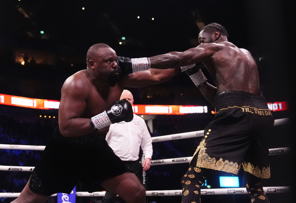Boxers Derek Chisora, left, and Deontay Wilder battle during a fight in London, Saturday April 4, 2026.(Adam Davy/PA via AP)