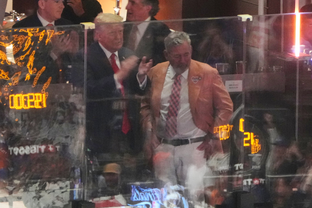 President Donald Trump talks with Knicks owner James Dolan during Game 3 of the NBA Finals basketball series between the New York Knicks and the San Antonio Spurs at Madison Square Garden in New York, Monday, June 8, 2026. (AP Photo/Mark Schiefelbein)