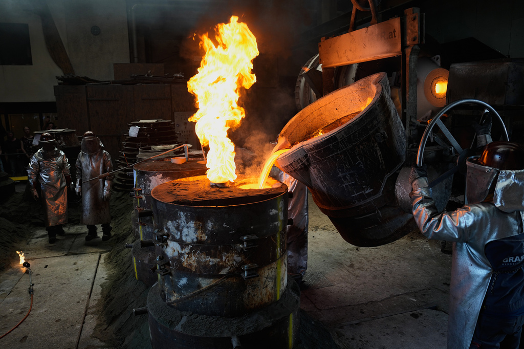 Workers cast bronze bells at the 400-year-old, family-owned Grassmayr bell foundry in Innsbruck, Austria, Friday, July 17, 2026. (AP Photo/Matthias Schrader)