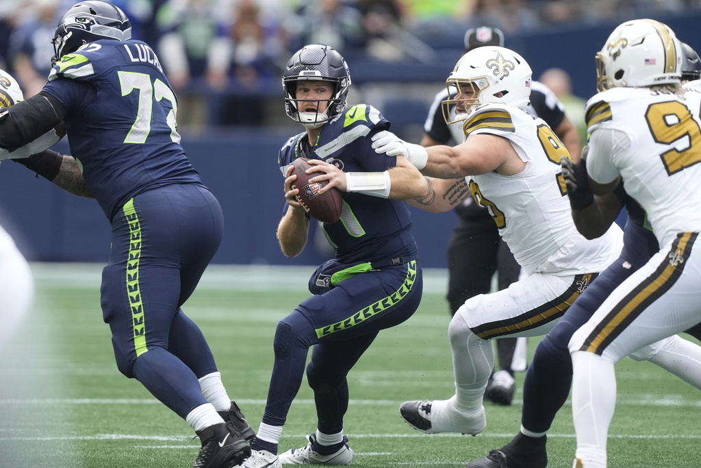 Seattle Seahawks quarterback Sam Darnold (14) scrambles during the first half of an NFL football game against the New Orleans Saints, Sunday, Sept. 21, 2025, in Seattle. (AP Photo/Stephen Brashear)