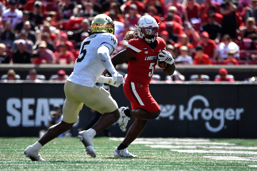 Louisville running back Keyjuan Brown (5) attempts to outrun the pursuit of Wake Forest defensive back Davaughn Patterson (5) during the second half of an NCAA college football game in Louisville, Ky., Saturday, Sept. 26, 2026. (AP Photo/Timothy D. Easley)