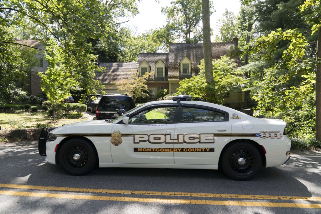 Montgomery county police patrol John Bolton's home as FBI agents search the house in Bethesda Md, Friday, August. 22, 2025. (AP Photo/Jose Luis Magana)