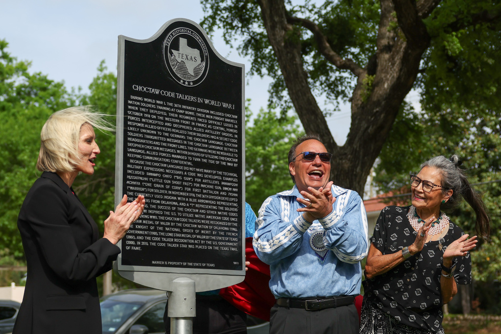 City council member Macy Hill, left, Chief Gary Batton of the Choctaw Nation of Oklahoma, center, and Nuchi Nashoba, president of the Choctaw Code Talkers Association, unveil the Choctaw Code Talkers historical marker on April 1, 20206 at Fort Worth's Veterans Memorial Park in Texas. (Christine Vo/Fort Worth Report via AP)