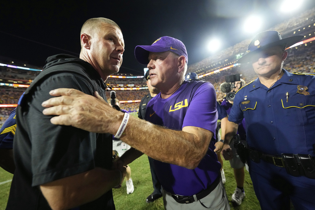 LSU head coach Brian Kelly, right, greets Florida head coach Billy Napier after an NCAA college football game, Saturday, Sept. 13, 2025, in Baton Rouge, La. (AP Photo/Gerald Herbert)