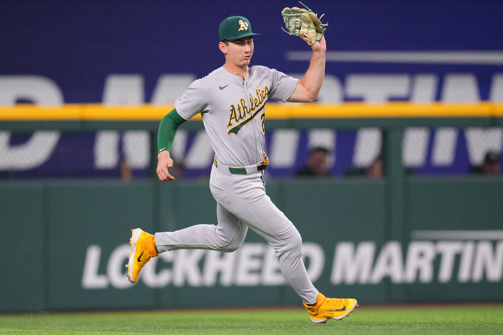 Athletics outfielder Tyler Soderstrom catches a sacrifice fly ball hit by Texas Rangers' Brandon Nimmo to score Danny Jansen during the third inning of a baseball game Saturday, April 25, 2026, in Arlington, Texas. (AP Photo/Julio Cortez)