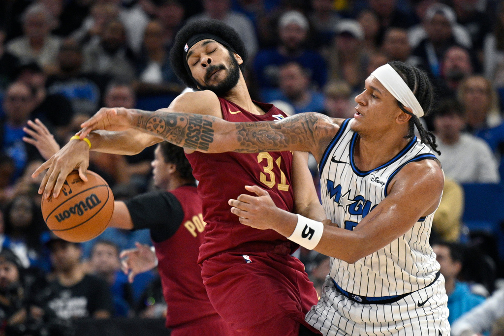 Orlando Magic forward Paolo Banchero (5) is fouled by Cleveland Cavaliers center Jarrett Allen (31) during the second half of an NBA basketball game, Saturday, Jan. 24, 2026, in Orlando, Fla. (AP Photo/Phelan M. Ebenhack)