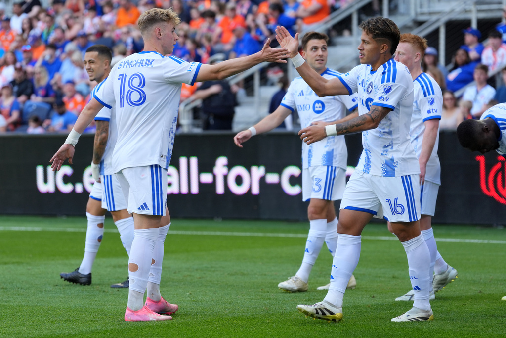 CF Montréal midfielder Wikelman Carmona (16) celebrates after a goal with midfielder Hennadiy Synchuk (18) during the first half of an MLS soccer match against FC Cincinnati, Sunday, March 22, 2026, in Cincinnati. (AP Photo/Kareem Elgazzar)