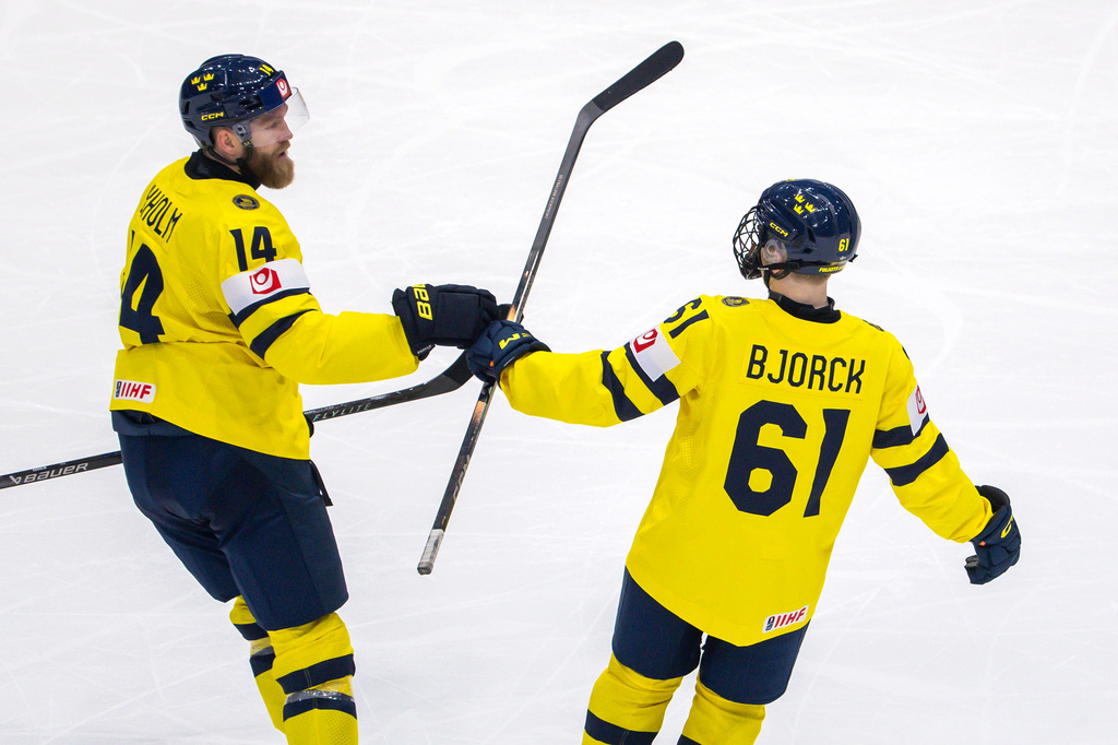 Sweden's Mattias Ekholm, left, celebrates with his teammate Sweden's Viggo Bjorck after scoring during the 2026 IIHF Men's Ice Hockey World Championship preliminary round group B game between Denmark and Sweden, in Fribourg, Switzerland, Sunday, May 17, 2026. (Salvatore Di Nolfi/Keystone via AP)