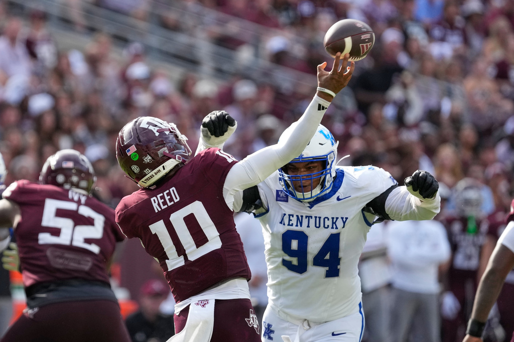 Texas A&M quarterback Marcel Reed (10) is pressured by Kentucky defensive lineman Tavion Gadson (94) during the second half of an NCAA college football game Saturday, Sept. 19, 2026, in College Station, Texas. (AP Photo/David J. Phillip)