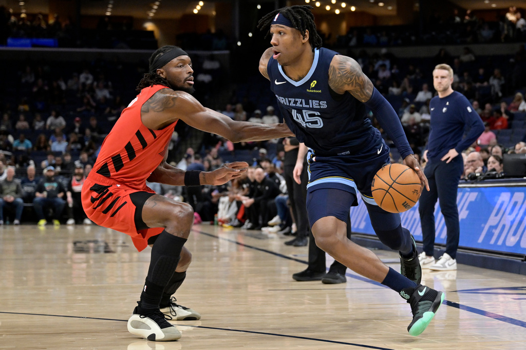 Memphis Grizzlies forward GG Jackson II (45) drives against Portland Trail Blazers forward Jerami Grant in the first half of an NBA basketball game, Wednesday, March 4, 2026, in Memphis, Tenn. (AP Photo/Brandon Dill)
