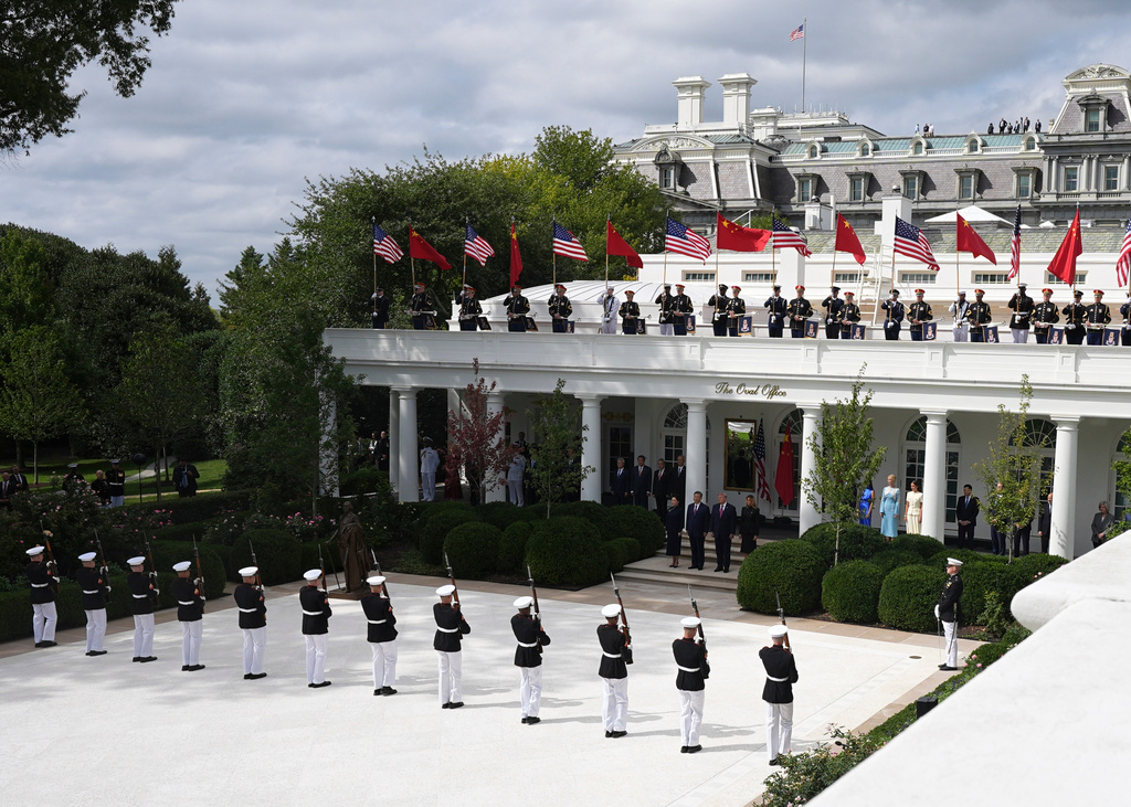 President Donald Trump, center right, first lady Melania Trump, right, China's President Xi Jinping, center left, and his wife Peng Liyuan watch a military review in the Rose Garden of the White House, Thursday, Sept. 24, 2026, in Washington. (AP Photo/Alex Brandon)