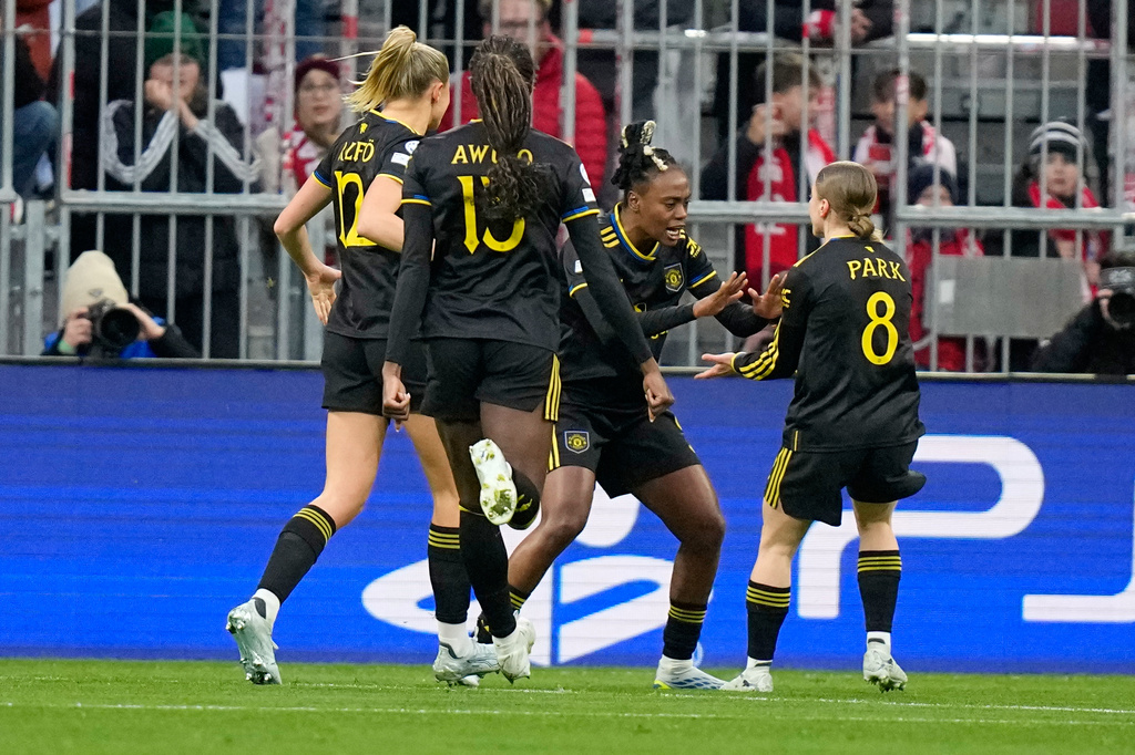 Manchester United's Melvine Malard, second right, celebrates scoring her side's frst goal during the Women's Champions League quarterfinal second leg soccer match between Bayern Munich and Manchester United in Munich, Germany, Wednesday, April 1, 2026. (AP Photo/Matthias Schrader)