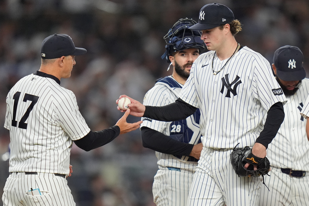 New York Yankees pitcher Cam Schlittler, right, hands the ball to manager Aaron Boone as he leaves during the seventh inning of a baseball game against the Kansas City Royals Friday, April 17, 2026, in New York. (AP Photo/Frank Franklin II)
